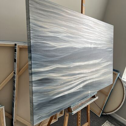 Large realistic painting of ocean waves at sunset