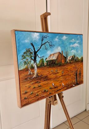 This acrylic framed painting features the rich ochre colours, and clear blue skies of the harsh Australian summer, only a few Emus and Cockatoos remain to survive  the sunburnt land