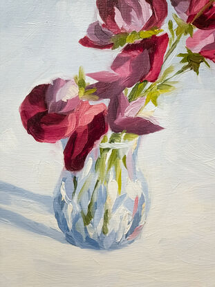 An oil painting of purple, pink, and red sweetpea flowers in a glass scotch thistle vase. The background has a soft gradient of white and light blue. There are visible brush strokes and texture. 