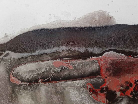 a large abstract of lava and black rock in Iceland. Molten magma. Black, white, red and silver