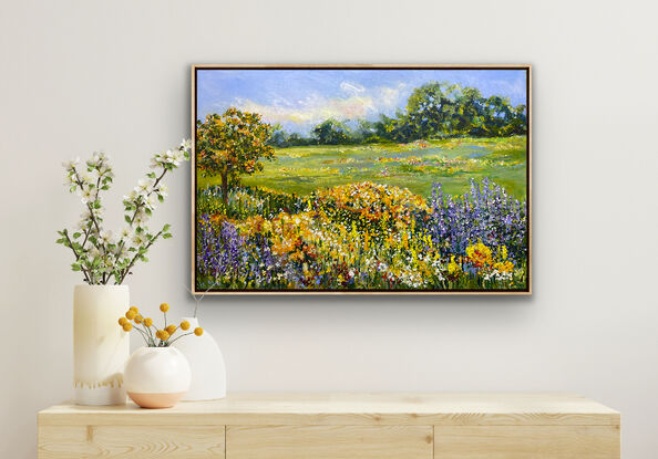 Splashes of red, orange and yellow flowers in the background between the summery sky and gentle mountain peaks. There are a profusion of flowers of all colours in the foreground. Including purple mauve light blue.  A summer field of flowers  that is relaxing  to immerse yourself in its calm and restful feeling. This is a happy piece and will be a soothing beautiful addition to your home. 