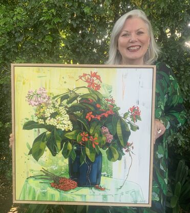 A framed, expressive still life painting of entangled flora in greens, yellows, reds and oranges.