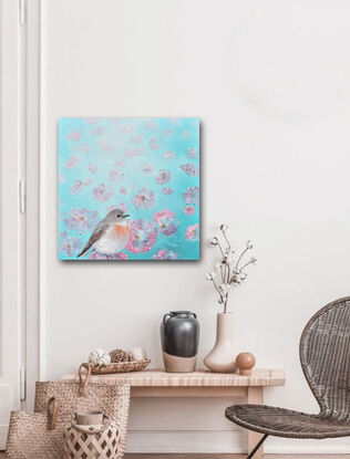 Textured oil painting of an Australian Scarlet Robin in the foreground of a field of dancing pink poppies. The robin bird has a light brown head, back and wings and a white breast with a touch of red. The pink poppies are on a green background.