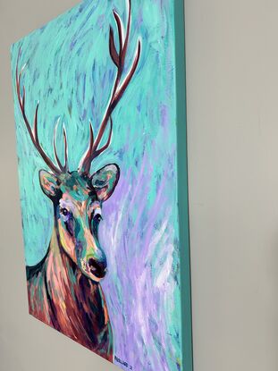 A deer face using a brightly coloured palette to show light and dark. On a abstract background of mixed lilac and a teal pale green 