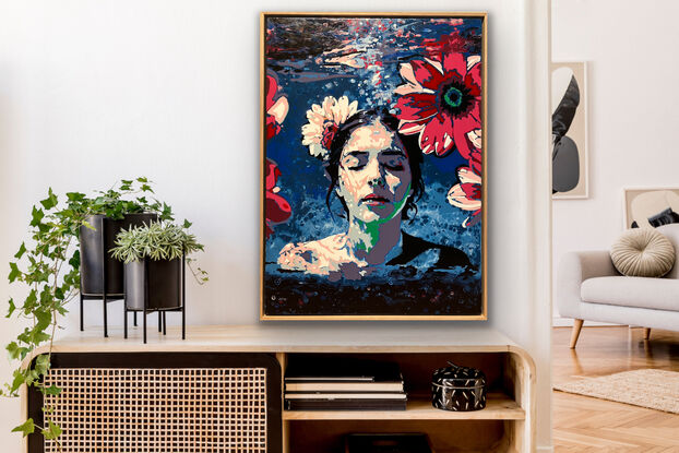 Portrait of a woman swimming with her head above the surface of the water, surrounded by pink flowers.