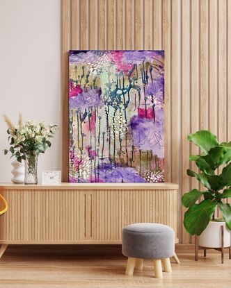 An image of a canvas full of dark hues of purple and navy with hints of magenta acrylic, covered in gold spray paint mixed with water