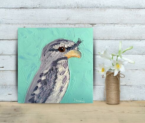 A cute Tawny Frogmouth painted in thick textured oil paints.