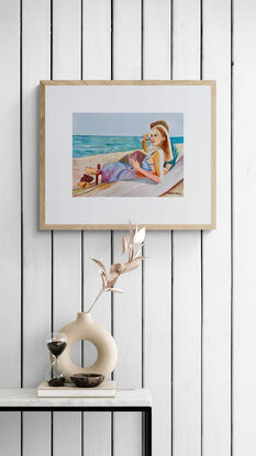 artwork which is the image of a couple sitting sipping red wine on the beach