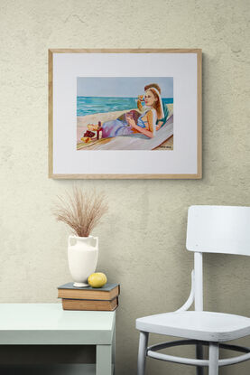 artwork which is the image of a couple sitting sipping red wine on the beach