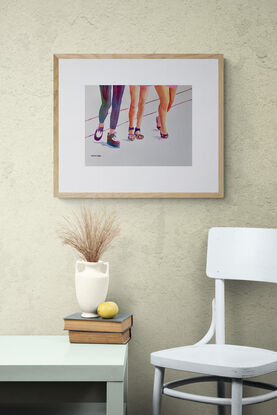 artwork which is the image of three women's legs and fashionable shoes as they walk along
