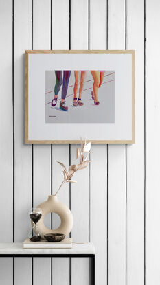 artwork which is the image of three women's legs and fashionable shoes as they walk along
