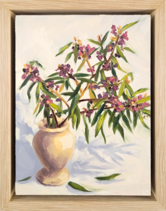 An oil painting of a sprig of the Australian native flower the hovea sitting in a small stone vase.  The hovea plant has small purple and pink flowers and the leaves small narrow and dark green.  The background is creamy white with the flowers casting a blue shadow. 