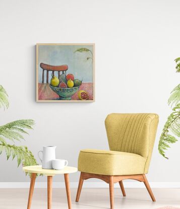 A brightly coloured bowl of fruit sits on a table, Fruit includes pears, lemons, figs. In front to the right is half a lemon. Bowl is turquoise and green