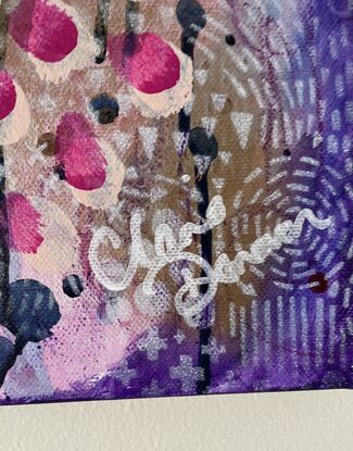 An image of a canvas full of dark hues of purple and navy with hints of magenta acrylic, covered in gold spray paint mixed with water