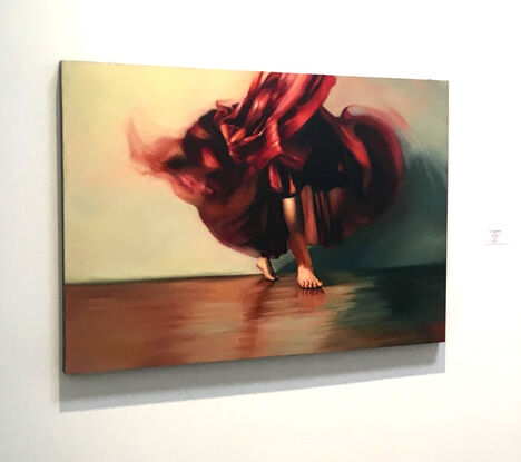 Woman in a red dress dances barefoot