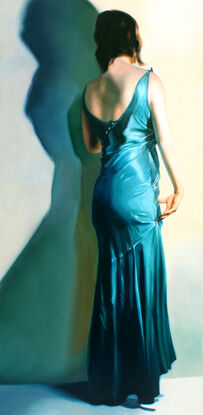 woman standing facing away from the viewer in a teal dress