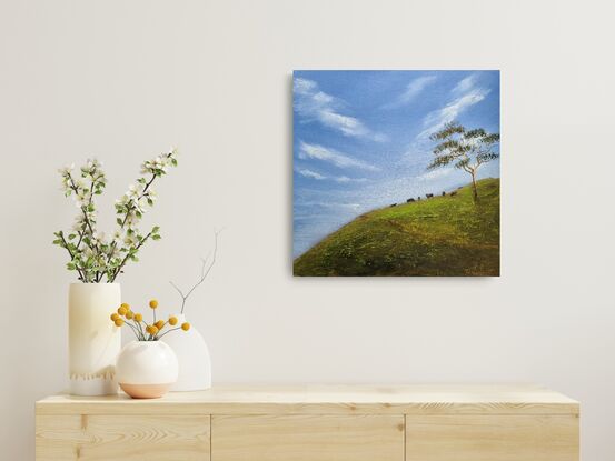 Blue sky with hillside and cows