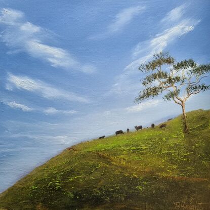 Blue sky with hillside and cows