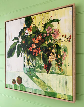 A framed, expressive still life painting of entangled flora in greens, yellows, reds, pinks and oranges.