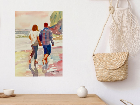 artwork which shows a couple walking companionably across the beach