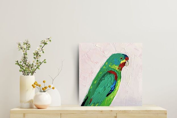 A small painting of an Australian Swift Parrot in textured oils.