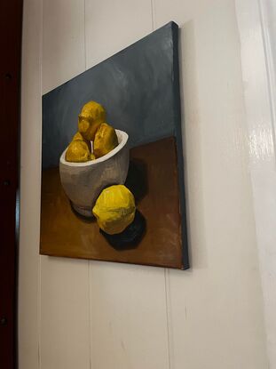 bowl of lemons on a table

