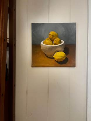 bowl of lemons on a table

