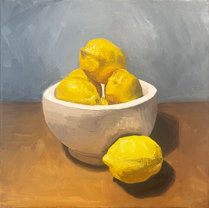 bowl of lemons on a table

