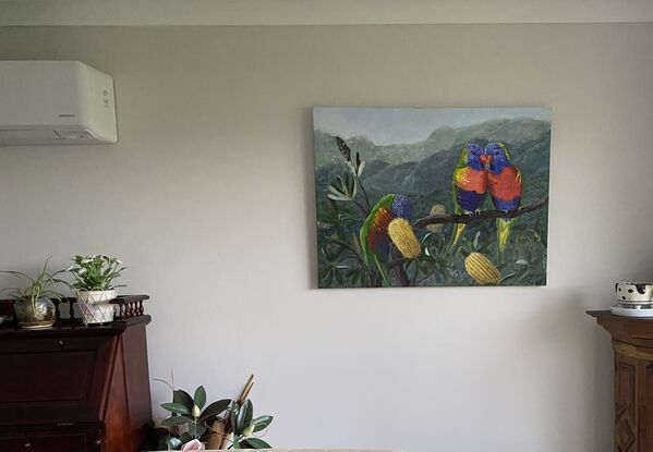 This is a vibrant piece which captures the colours of the Lorikeets. They are offset on a soft background of native  bush. 