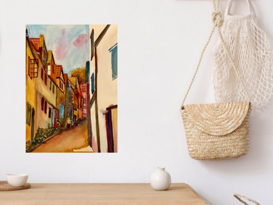 artwork which shows a view of looking up through a narrow steep village street

