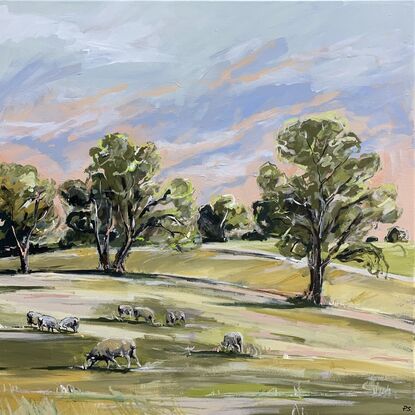 Rolling green hills scattered with grazing sheep. The sky is beginning to turn from pink to blue. Gum trees line the horizon.