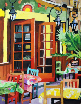 The artwork is a vibrant, expressive painting featuring an outdoor café scene. The use of bold, contrasting colors gives the piece an energetic and lively atmosphere, reminiscent of the Fauvist movement with its disregard for realistic coloration and emphasis on painterly qualities. The composition includes an open French door, colorful chairs, tables with patterned tablecloths, and street lamps, framed by lush greenery. The brushstrokes are visible and confidently applied, adding to the overall texture and dynamism of the scene. The sunlight seems to be filtering into the café, creating a warm and inviting ambiance.