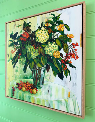 A framed, expressive still life painting of entangled flora in greens, yellows, reds, pinks and oranges.