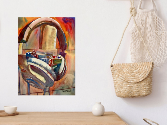 artwork which is the image of a pair of headphones hanging off a microphone

