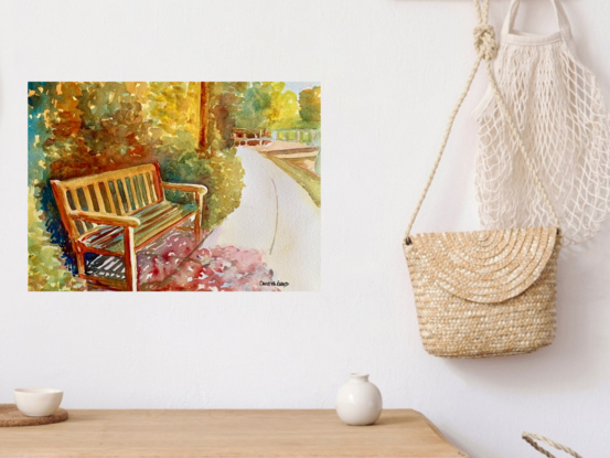 artwork which is the image of a bench on the edge of a riverside pathway

