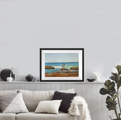 Two figures, a mum and daughter, stand on the rocks watching the turquoise waves at the beach. A small dog runs past and two seagulls look on. The cobalt blue and turquoise of the sea are set against the warm sienna of the rocks.