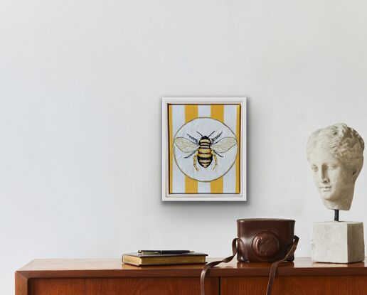 Just a bee on a plate with yellow and white striped background with lots of texture