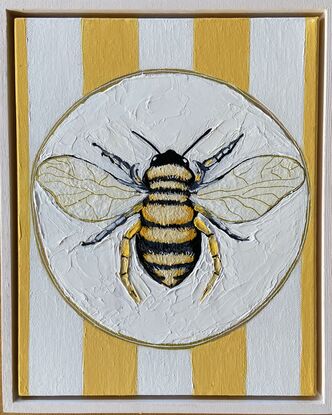 Just a bee on a plate with yellow and white striped background with lots of texture