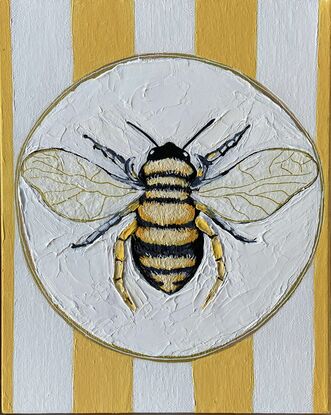 Just a bee on a plate with yellow and white striped background with lots of texture