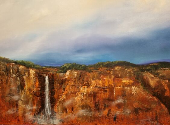 Red escarpment with waterfall