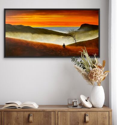 Man meditating on mountain and ocean views in sunset 