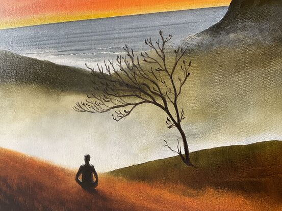 Man meditating on mountain and ocean views in sunset 