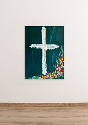 White Cross with yellow, red, purple, blue, pink flowers growing around the cross