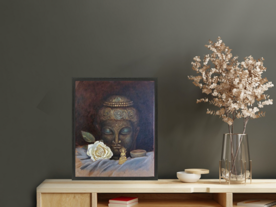 A still life painting of a large Buddha head statue in a dark bronze and green, with a miniature seated golden brass Buddha in the foreground. On the sides lay a white rose and a bronze singing bowl.