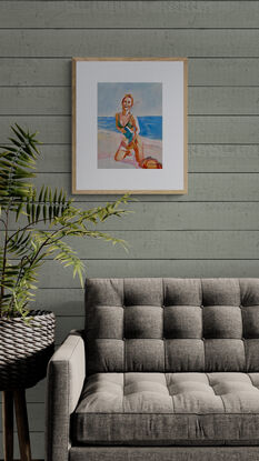 image of woman laughing and smiling widely whilst kneeling on a towel on the beach




