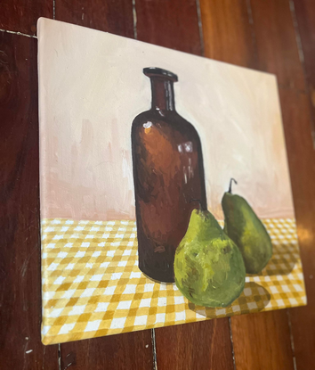 Antique bottle, pears on gingham tablecloth