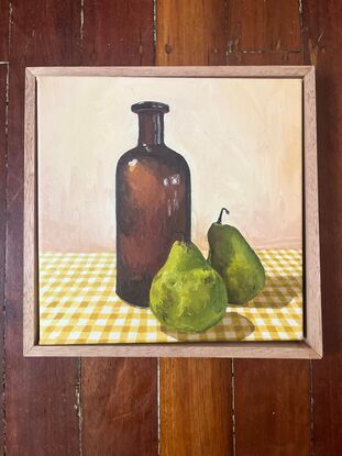 Antique bottle, pears on gingham tablecloth