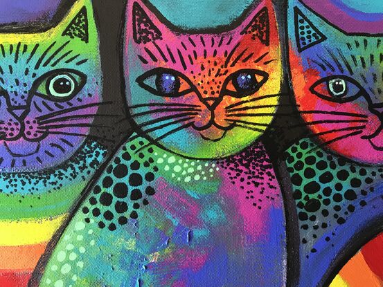 Three abstract, rainbow coloured cats.