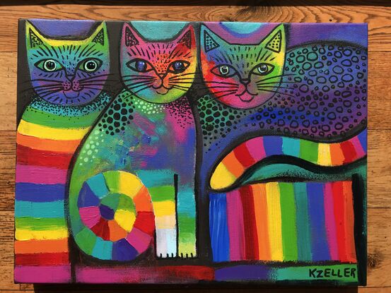 Three abstract, rainbow coloured cats.