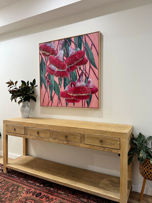 Red Silver princess flowering gum blossoms against a blush pink background and green patterned leaves